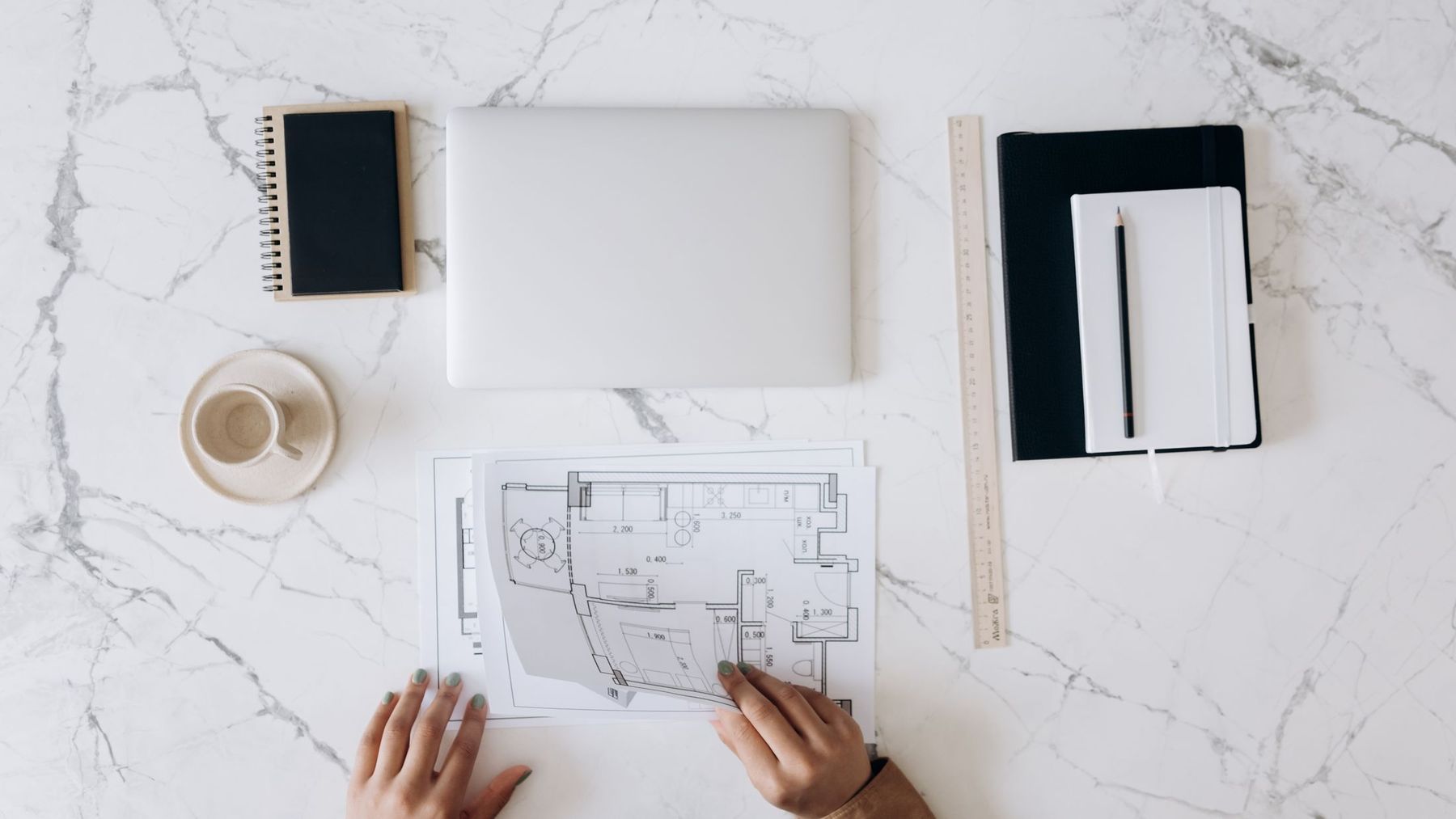 Sunlit plans and drawings spread on a table