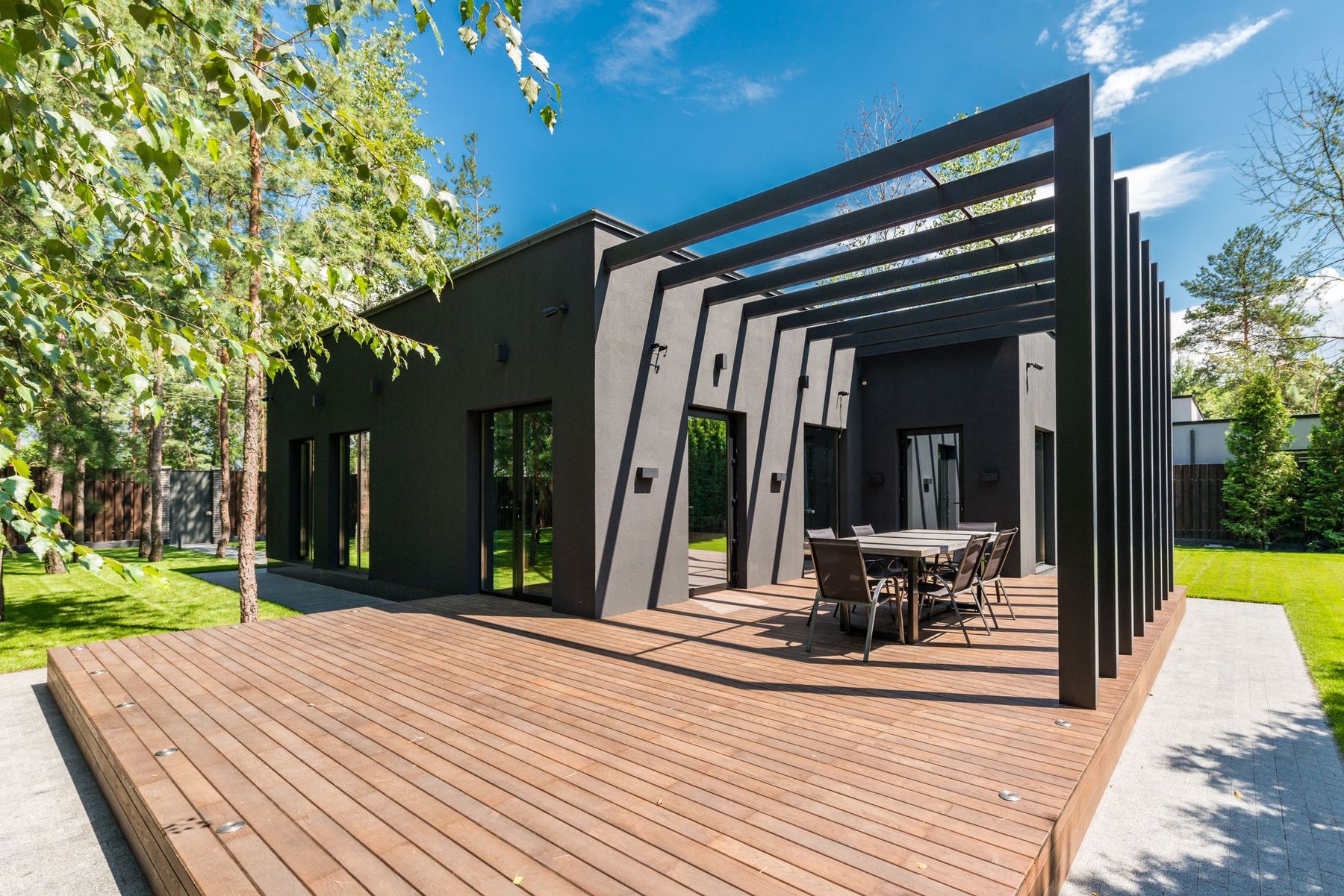 Sunny modern deck and pergola off a custom home