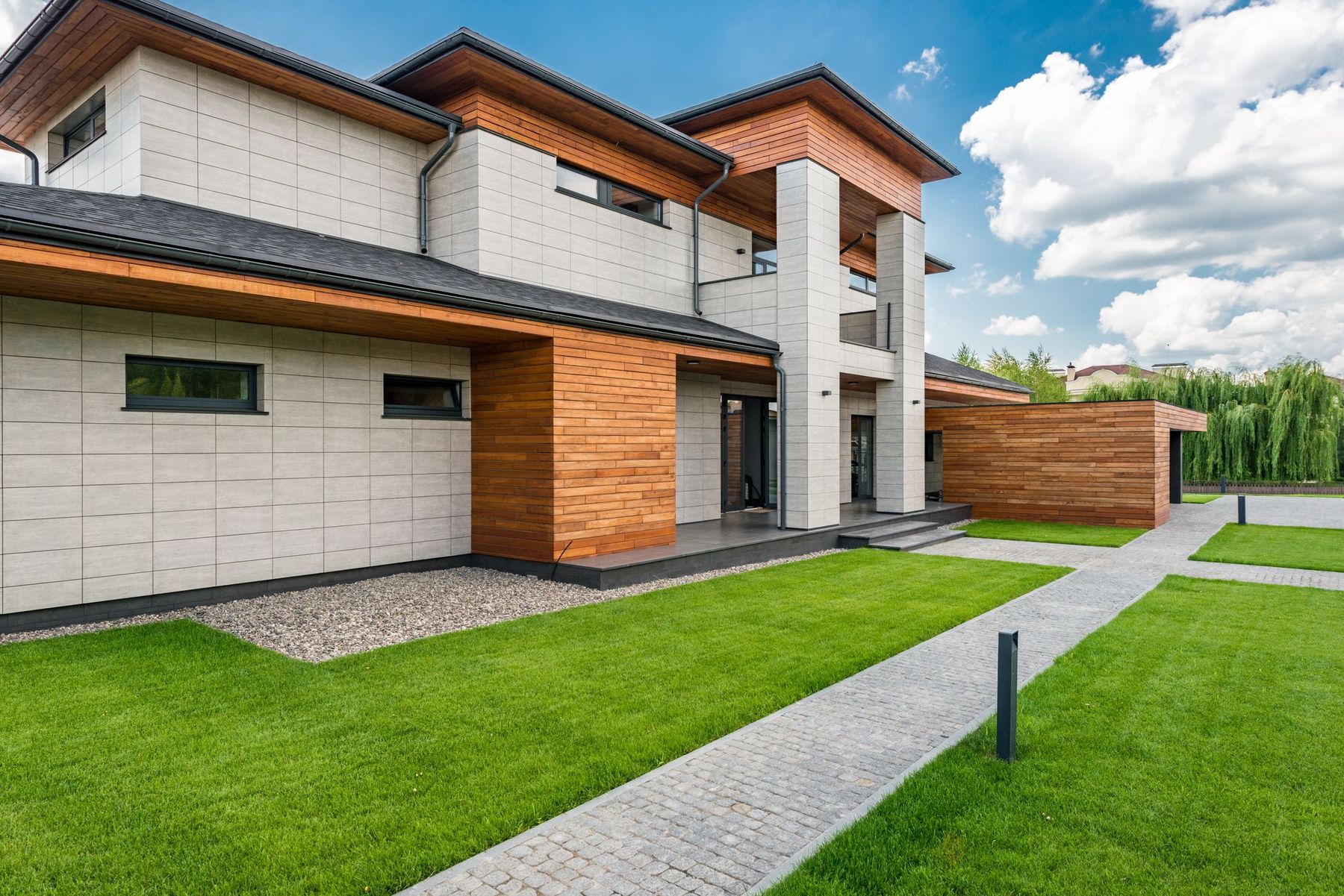 A bright modern home exterior with warm wood accents